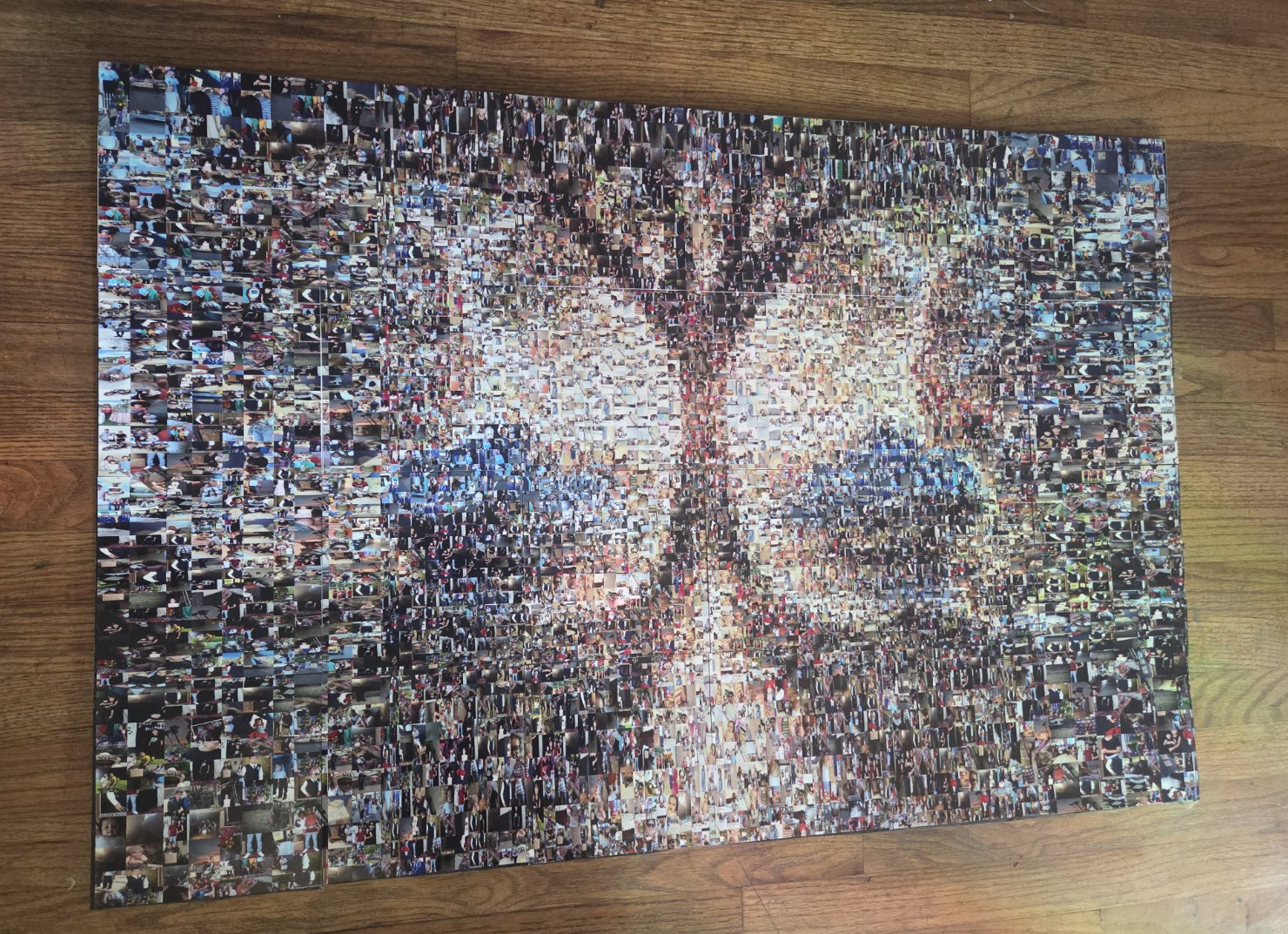 An intentionally angled, physical view of the mosaic showing its full edges on wood