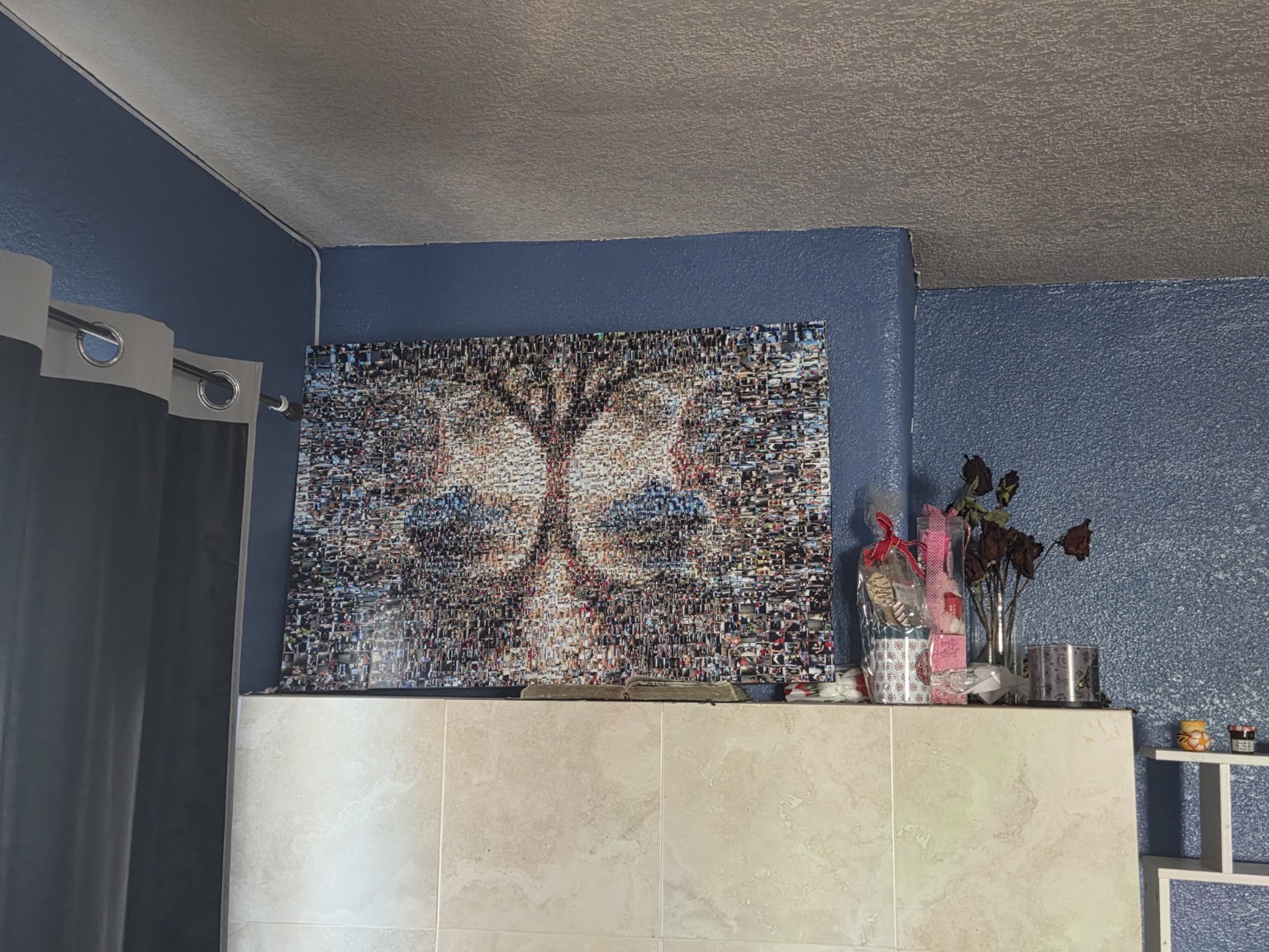 The finished Inheritance of Light mosaic displayed in its room against a blue wall, showing the real physical artwork in place
